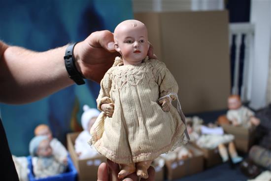 A Heubach character doll, intaglio eyes on shoulder plate broken, 18in., a Heubach character baby, intaglio eyes, hard body, 9in. and a